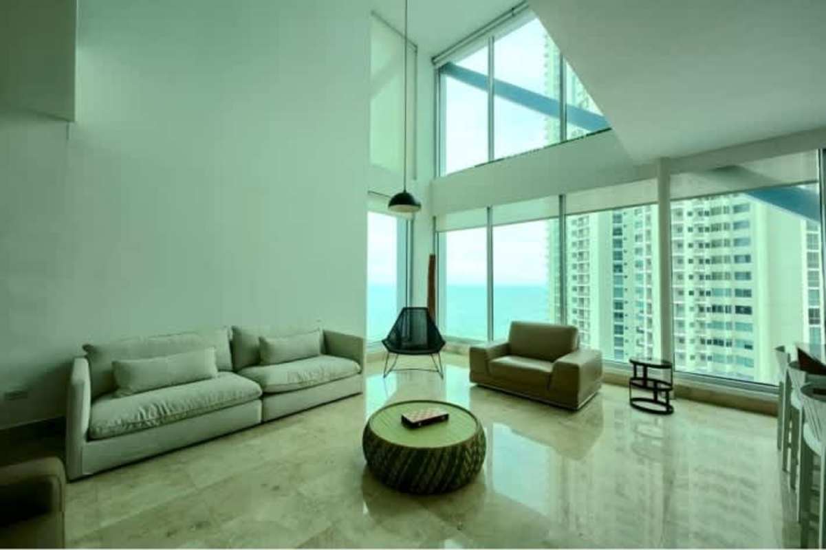 Open kitchen with center island, stainless appliances, floor-to-ceiling windows at Loft 41 Punta Pacifica Panama