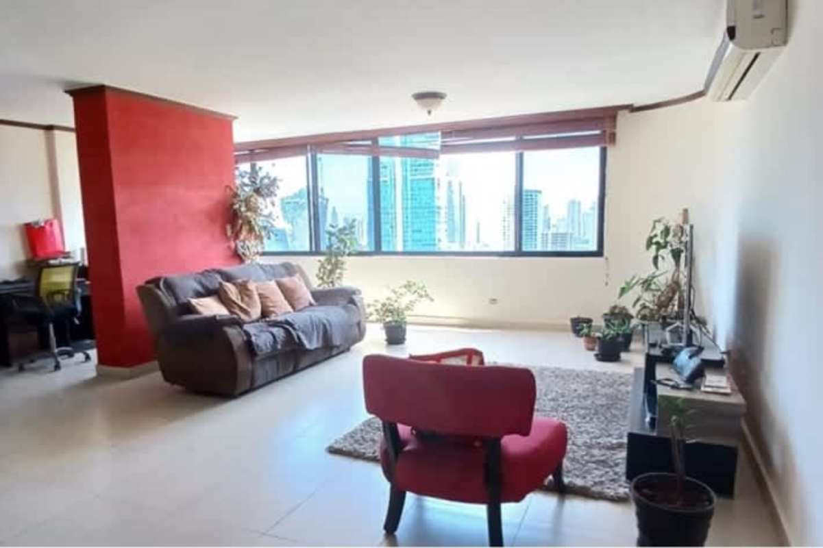 Living room with large windows and city skyline view at PH Marbella Tower Panama