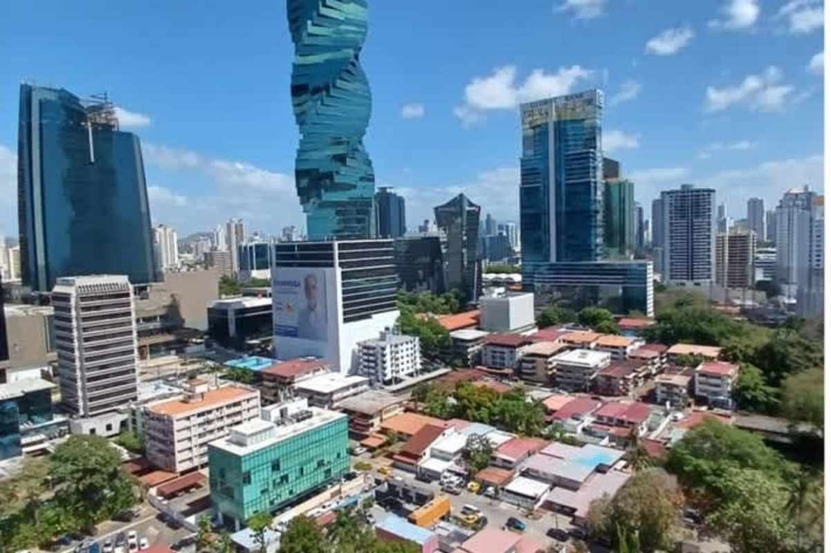 Kitchen with granite countertops, wooden cabinets, window and appliances in PH Marbella Tower Panama City