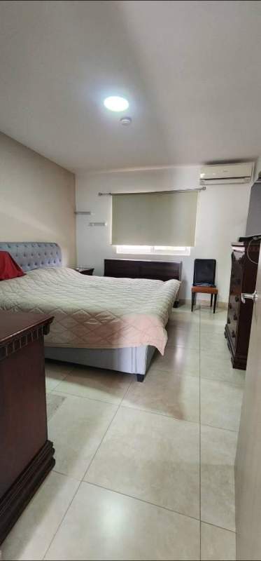 Bedroom with upholstered bed, tiled floor, AC Reserva de Versalles Panama