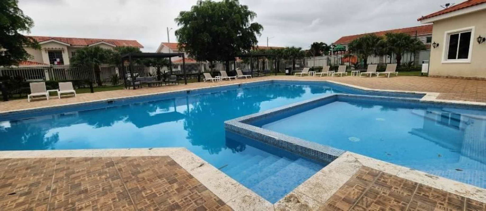 Swimming pool area with jacuzzi, pergola seating in gated community Panama