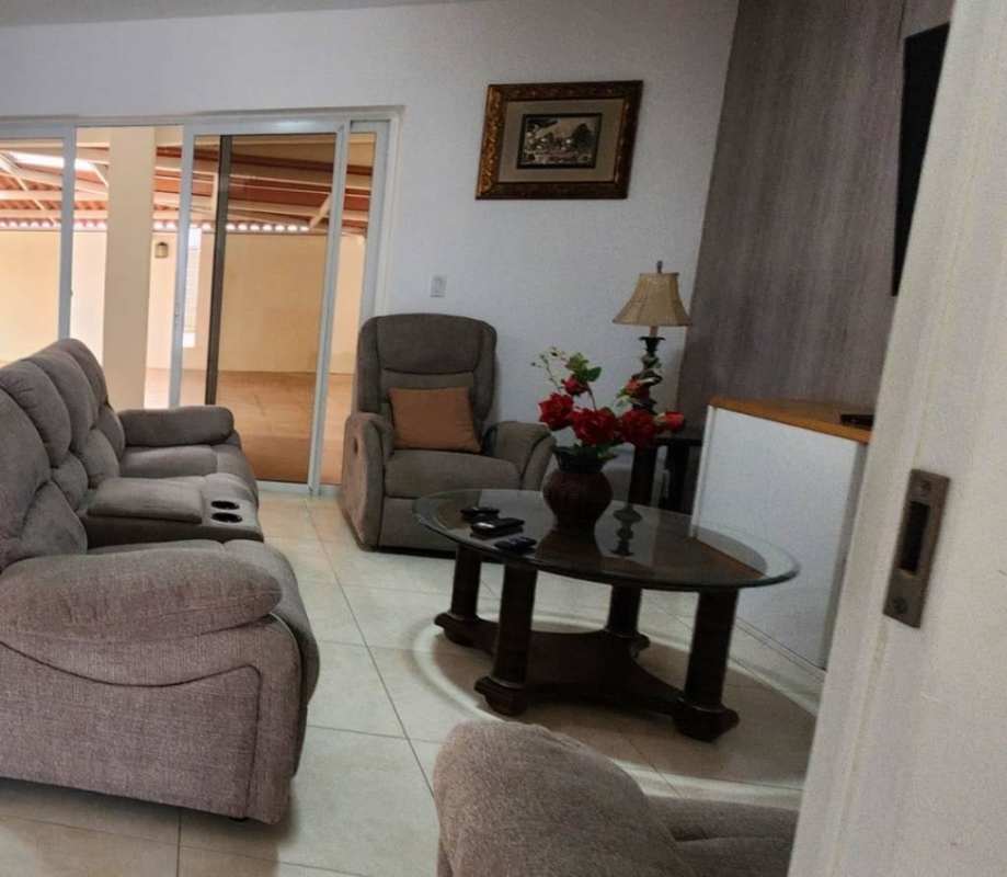 Living room with reclining sofas, coffee table, sliding glass doors to patio Panama