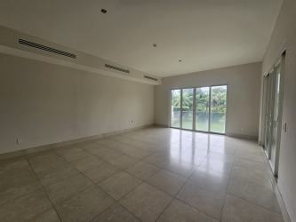 Bright living room with large sliding glass doors and lagoon view at PH Laguna Buenaventura
