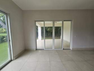 Modern living area with sliding door to garden patio in beachfront condo at Buenaventura