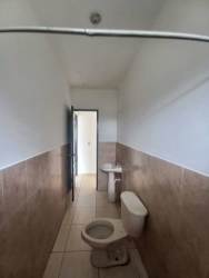 Bathroom with tiled walls, walk-in shower, sink and toilet Residencial Aqualina Panama