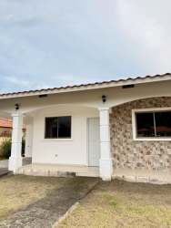 Modern minimalist kitchen with L-shaped counter tiled walls in house for sale David Panama