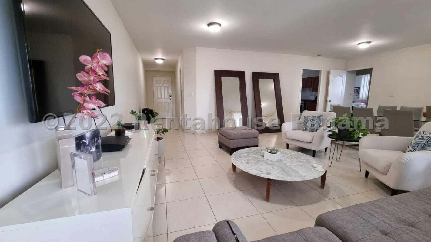 Bright living space with modern mirrors, mounted TV and neutral colors in Punta Pacifica Panama