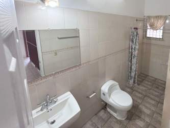 Minimalist twin bedroom with AC, window and tiled floor at Punta Chame villa