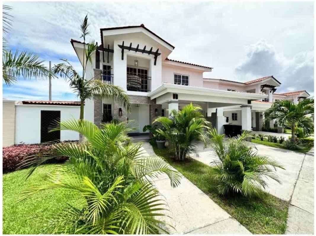 Remodeled marble countertop kitchen with wood cabinetry and pendant lights in Quintas de Versalles Panama City
