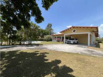 Large covered wraparound terrace with fans, pool and garden view in Coronado beach home