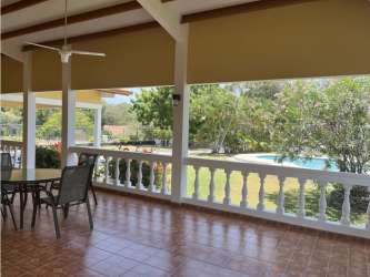 Comfortable bedroom with ceiling fan tile floors in Coronado Golf Beach House Panama