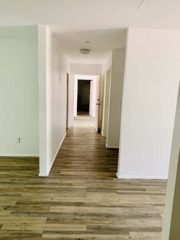 Bright hallway with laminate wood floors leading to bedrooms Clayton Panama