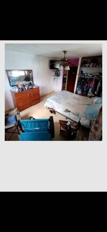 Bedroom with windows, ceiling fan, tiled floor, garden view house for sale Panama