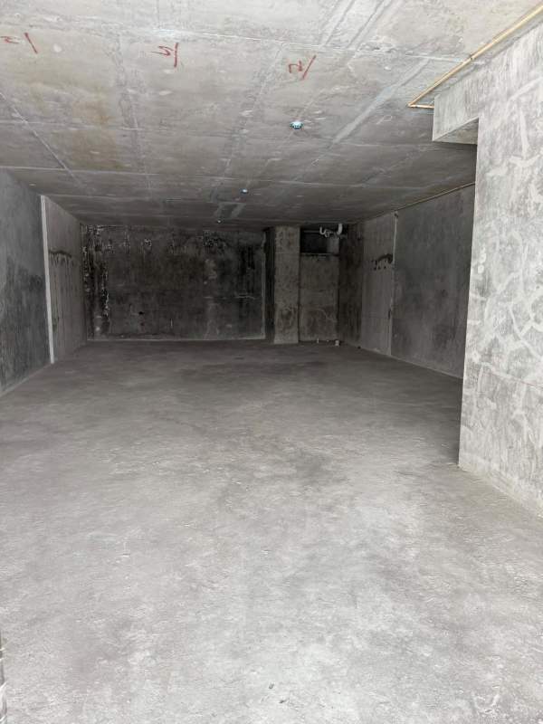 Interior raw concrete unfinished double height commercial space with mezzanine floor for customization City Mall Panama