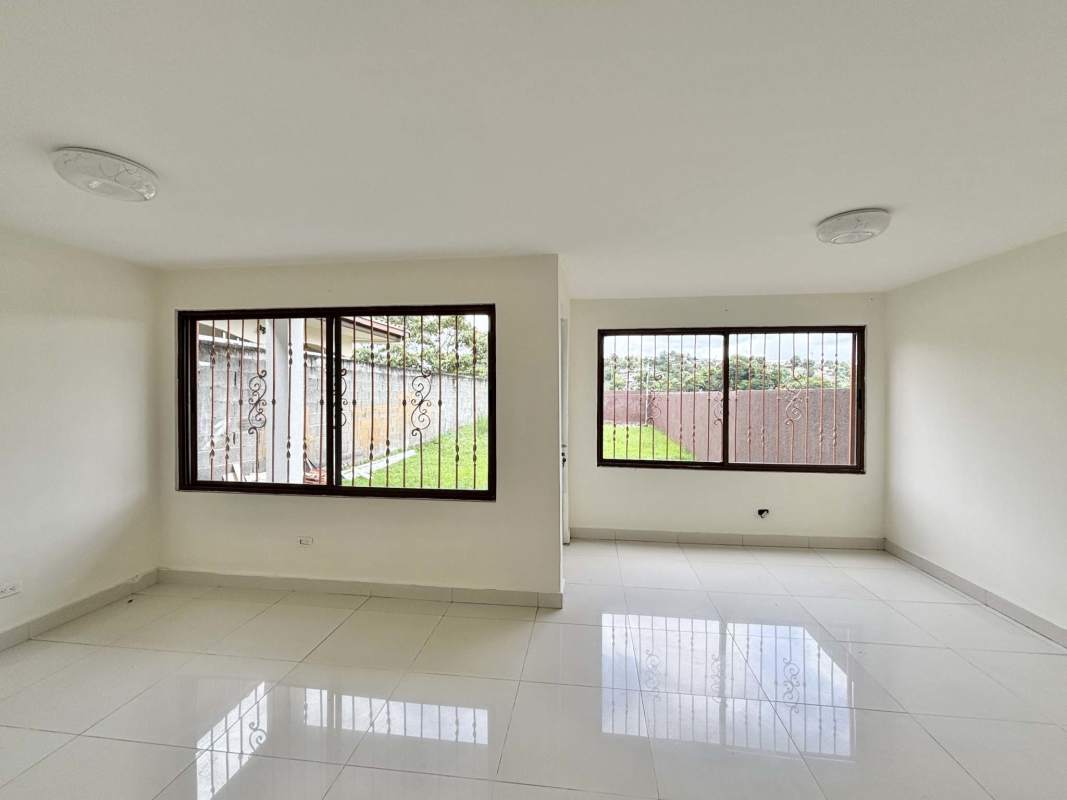 Spacious living room with tiled floors and large windows in Green Village Panama house for rent