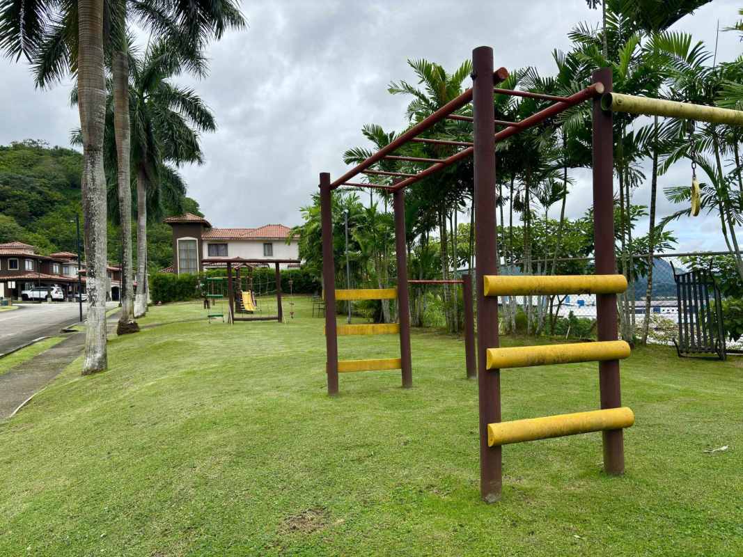 Children's play area with slides swings and gardens at Green Village gated community Panama
