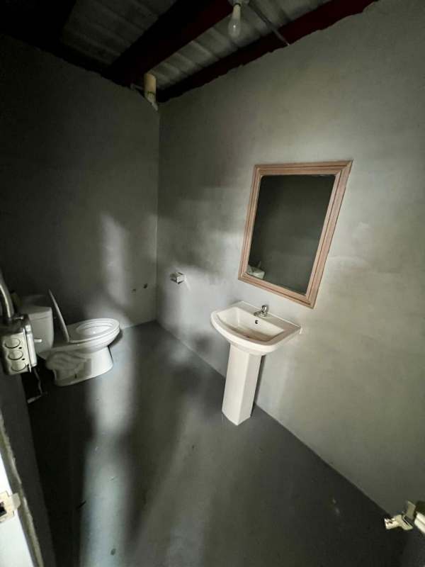 Interior industrial warehouse with mezzanine level, high ceilings and open concrete floor in Panama City