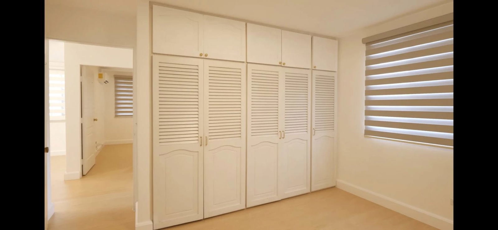 Bedroom with built-in closet, striped blinds, and neutral colors in Albrook house for rent