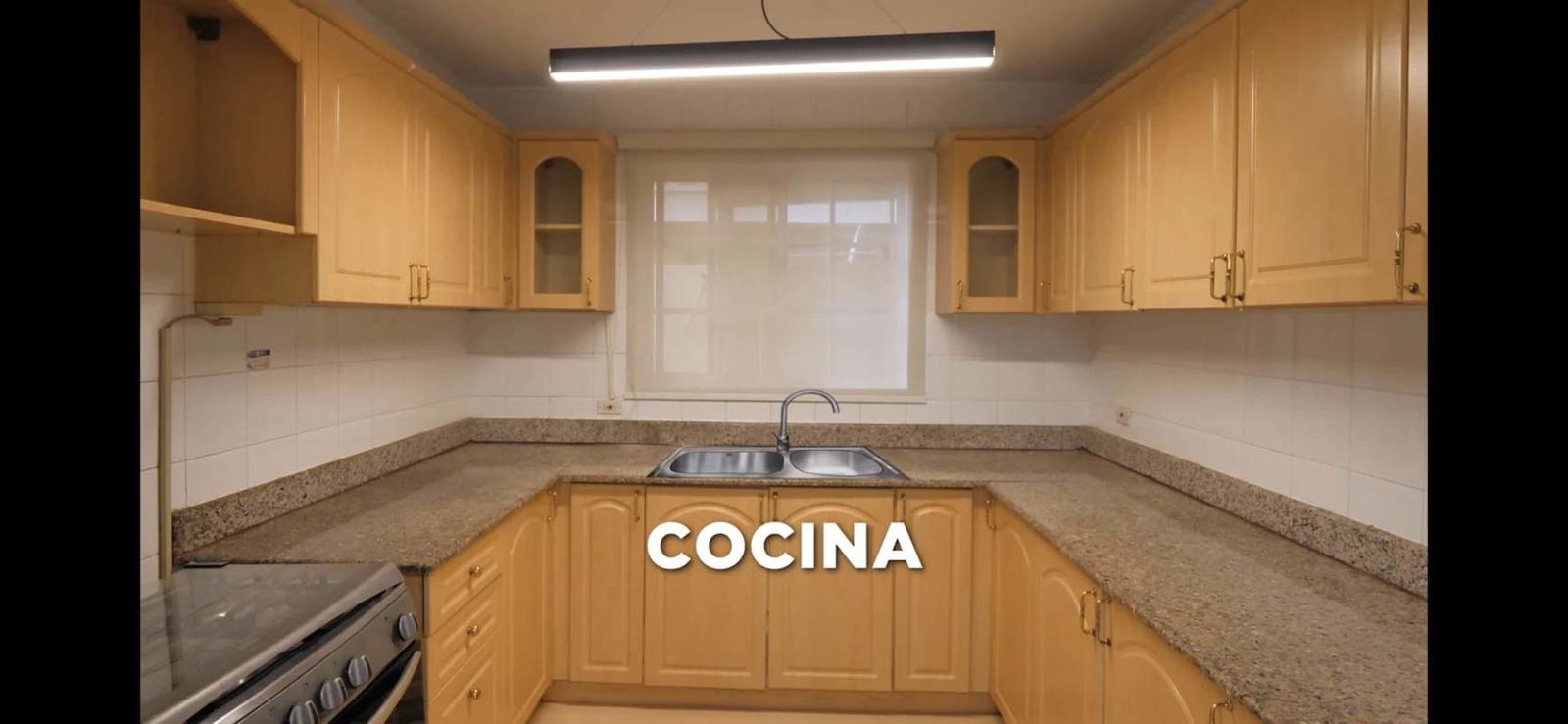 Traditional style kitchen with granite countertops, wooden cabinets, double sink, and window in Albrook rental house