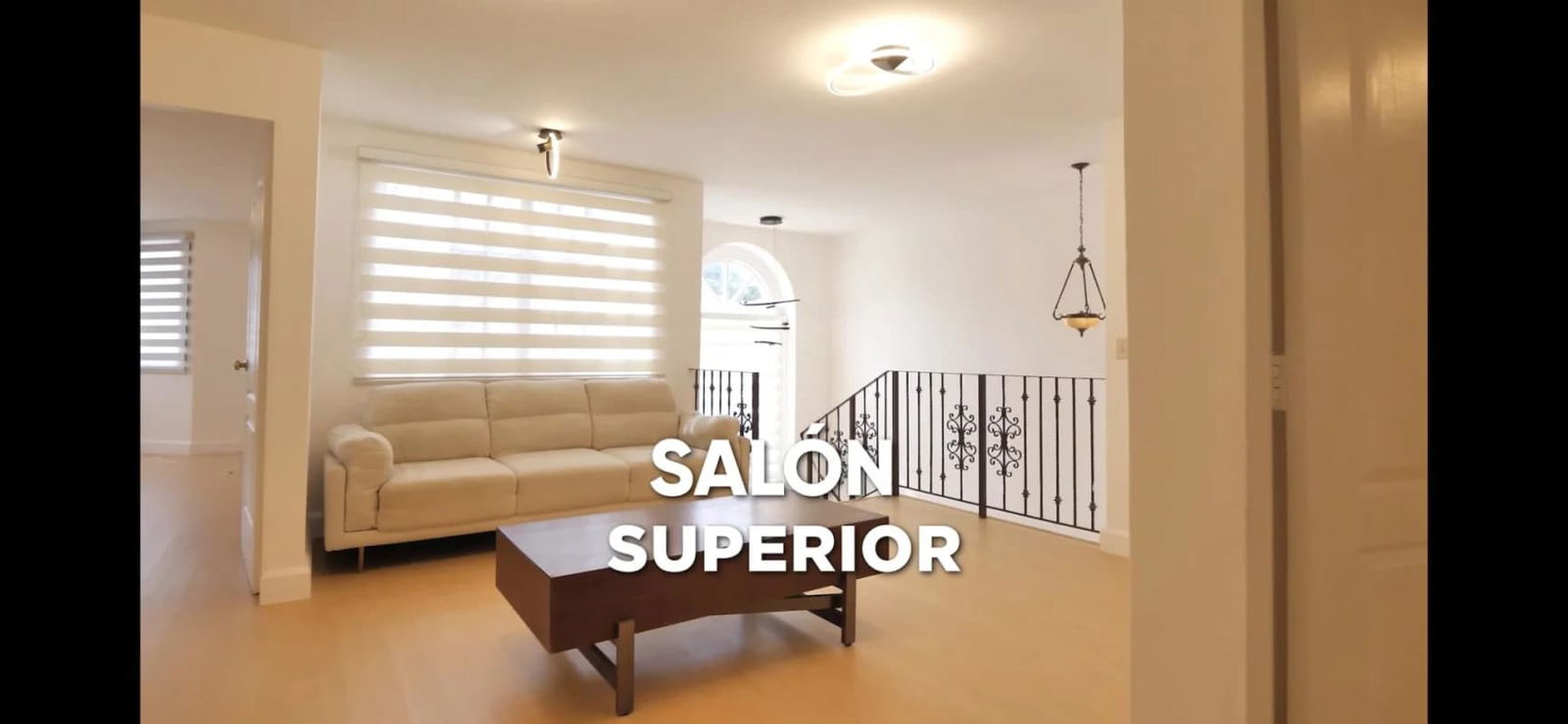 Modern upper lounge with sectional sofa, zebra blinds, natural light in Albrook house rental