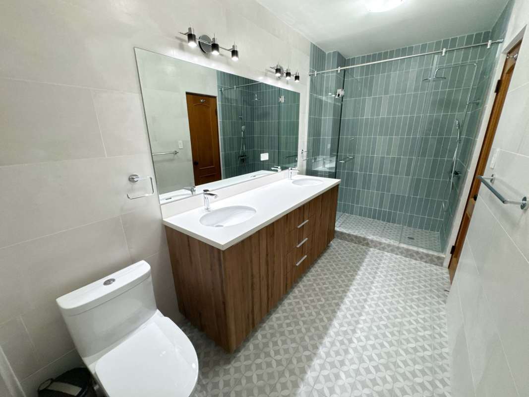 Stylish bathroom with dual sinks glass shower tile finishes in PH Star & Herald Casco Viejo