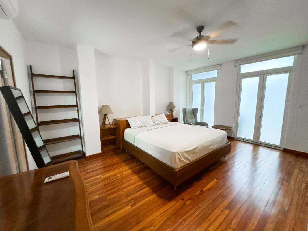 Bright bedroom with balcony wooden floors AC ceiling fan PH Star & Herald Casco Viejo Panama