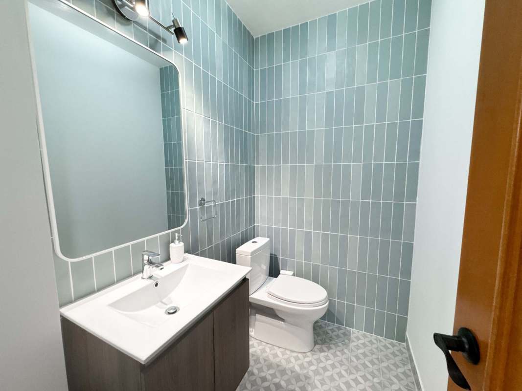 Modern bedroom with large window wood flooring ceiling fan PH Star & Herald Casco Viejo Panama