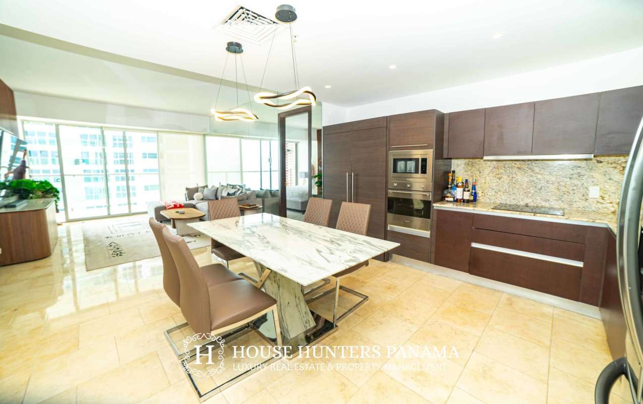 Modern dining area adjacent to luxury kitchen at The Ocean Club Punta Pacifica Panama City