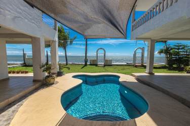 Swimming pool with ocean view patio at beachfront compound on Malibu Beach Panama