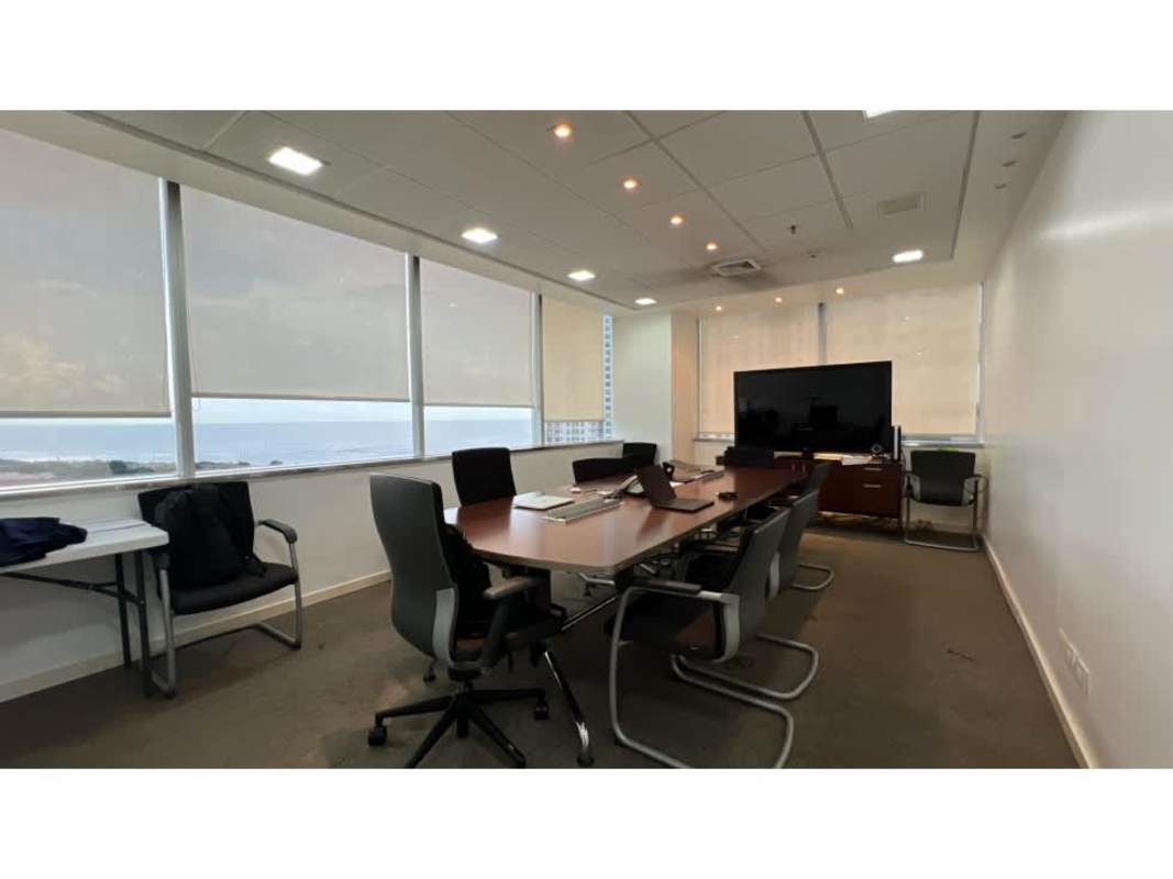 Bright office space with open workstation layout and panoramic city-ocean view at Torres de las Americas