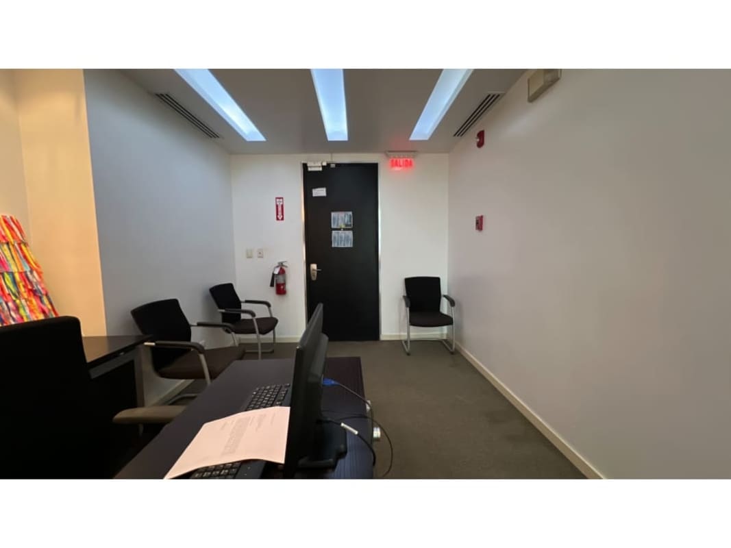 Modern office setup with workstations, ample lighting, ocean-city view at Torres de las Americas