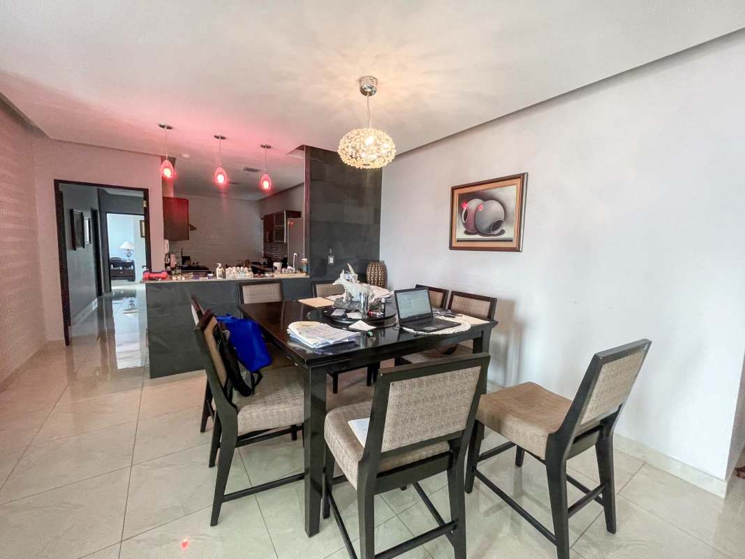 Modern open plan dining and kitchen space with pendant lighting in PH Windows Tower San Francisco Panama