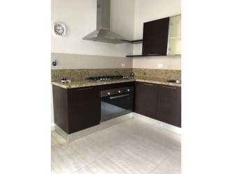 Modern kitchen with granite counters, dark cabinetry, stainless appliances in PH Nativa Panama