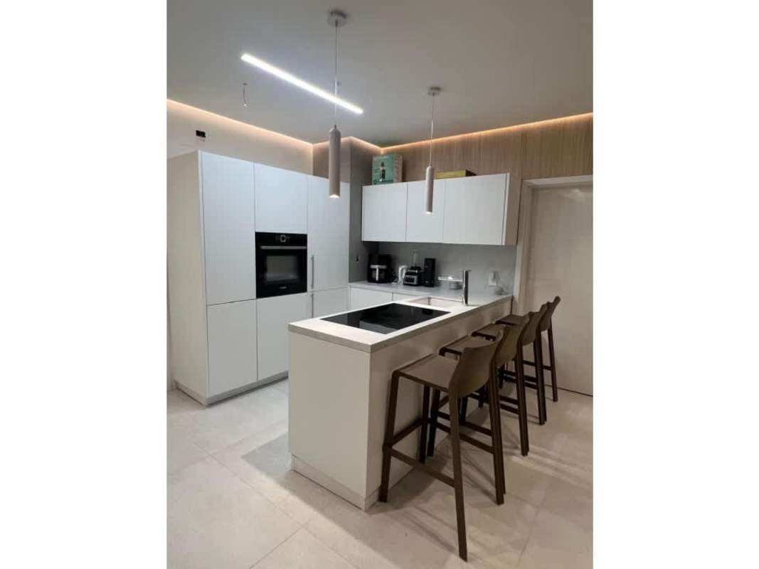 Bright bedroom with large window ocean view, walk-in closet and stylish furnishings in Victory Wellness Coco del Mar