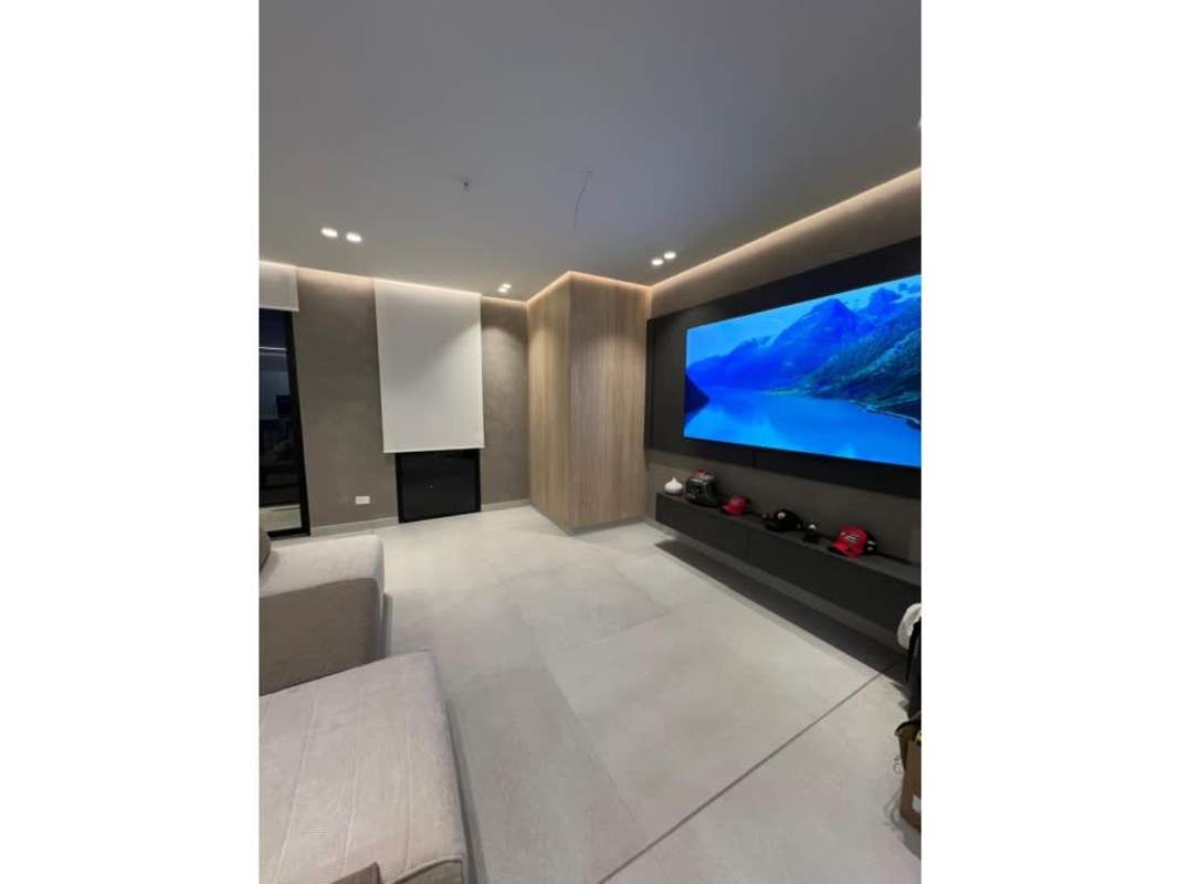 Indoor pool lounge with wooden loungers and skyline views at PH Victory Wellness Coco del Mar