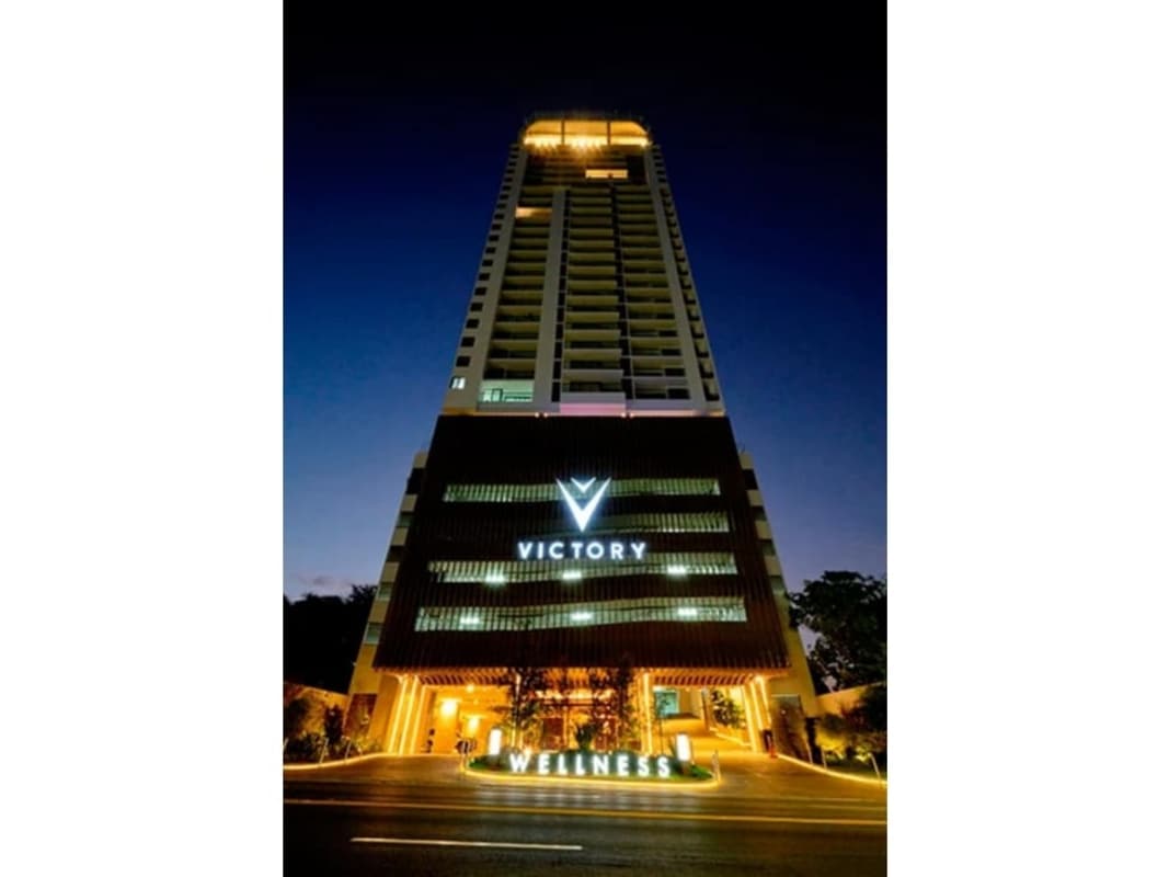 Night view of illuminated Victory Wellness high-rise in Coco del Mar Panama City