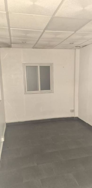 Small room with tiled ceiling and frosted window in commercial warehouse Pueblo Nuevo Panama City