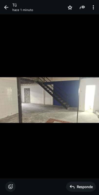 Open industrial space with blue accent wall and mezzanine staircase inside warehouse Pueblo Nuevo Panama