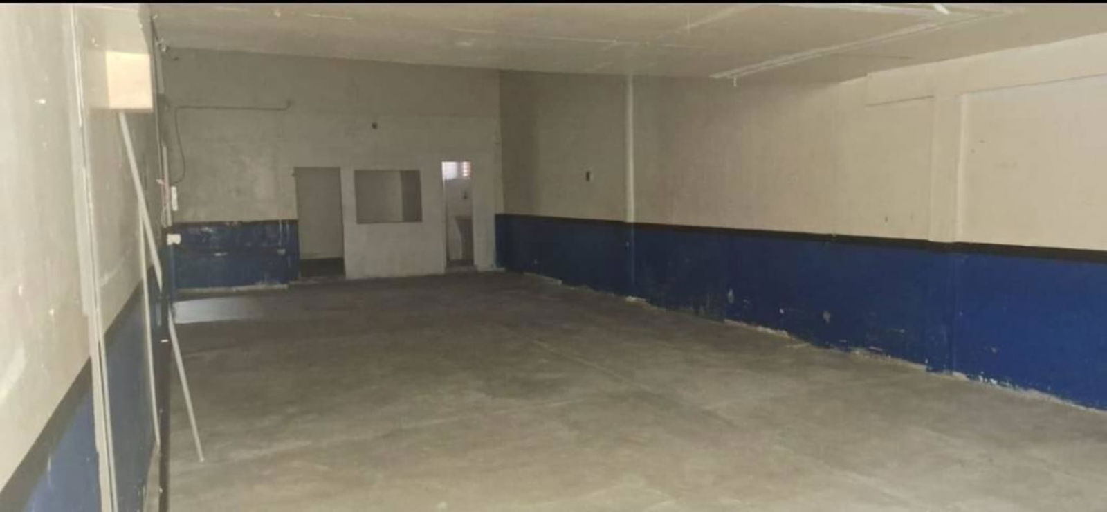 Empty room with drop ceilings suitable for storage or small office inside warehouse in Pueblo Nuevo Panama City