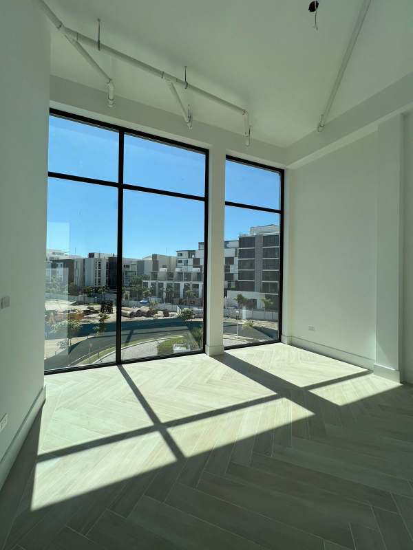 Spacious bedroom with marble flooring, large windows and walk-in closet in Ocean Reef Villa