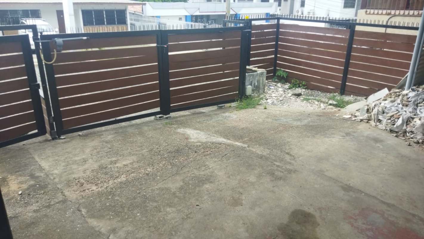 Driveway with swing metal gate wood fence commercial property Los Angeles Panama