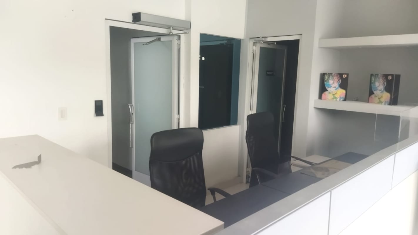 Reception lobby with glass partitions black chairs minimalist design commercial house Panama City