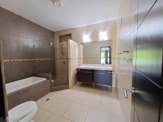 Bathroom with glass shower and ceramic tiles Panama Pacifico apartment