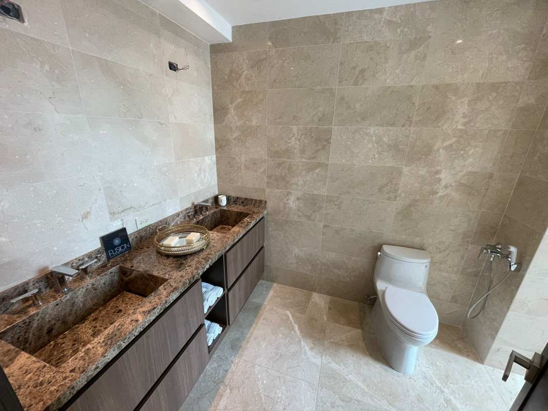 Luxury bathroom with marble double sink vanity and modern fixtures in PH Ocean House Santa Maria Panama