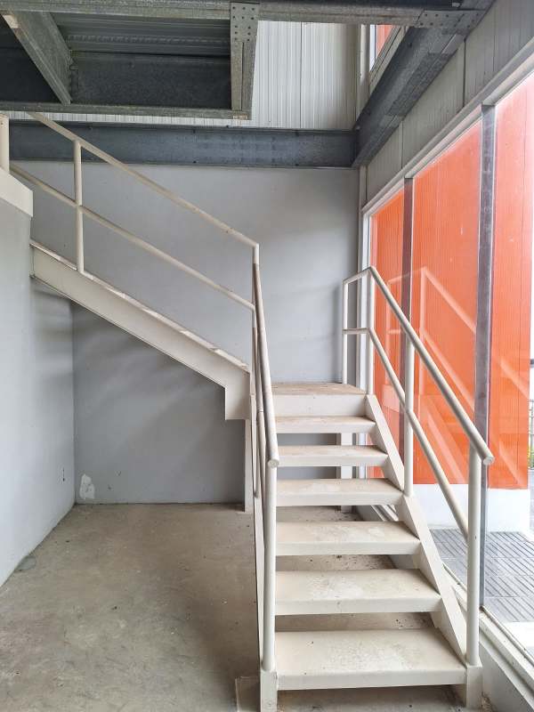 Industrial staircase with large windows and metal beams in warehouse Panapark Tocumen Panama