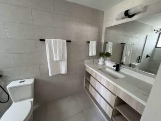 Spacious modern bathroom with gray ceramic tiles and walk-in shower Terra Viva Coronado Panama