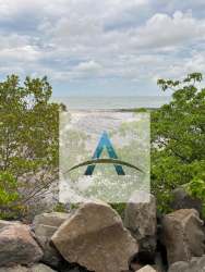 Natural rocky beachfront with ocean waves and tropical foliage in Punta Roca Panama