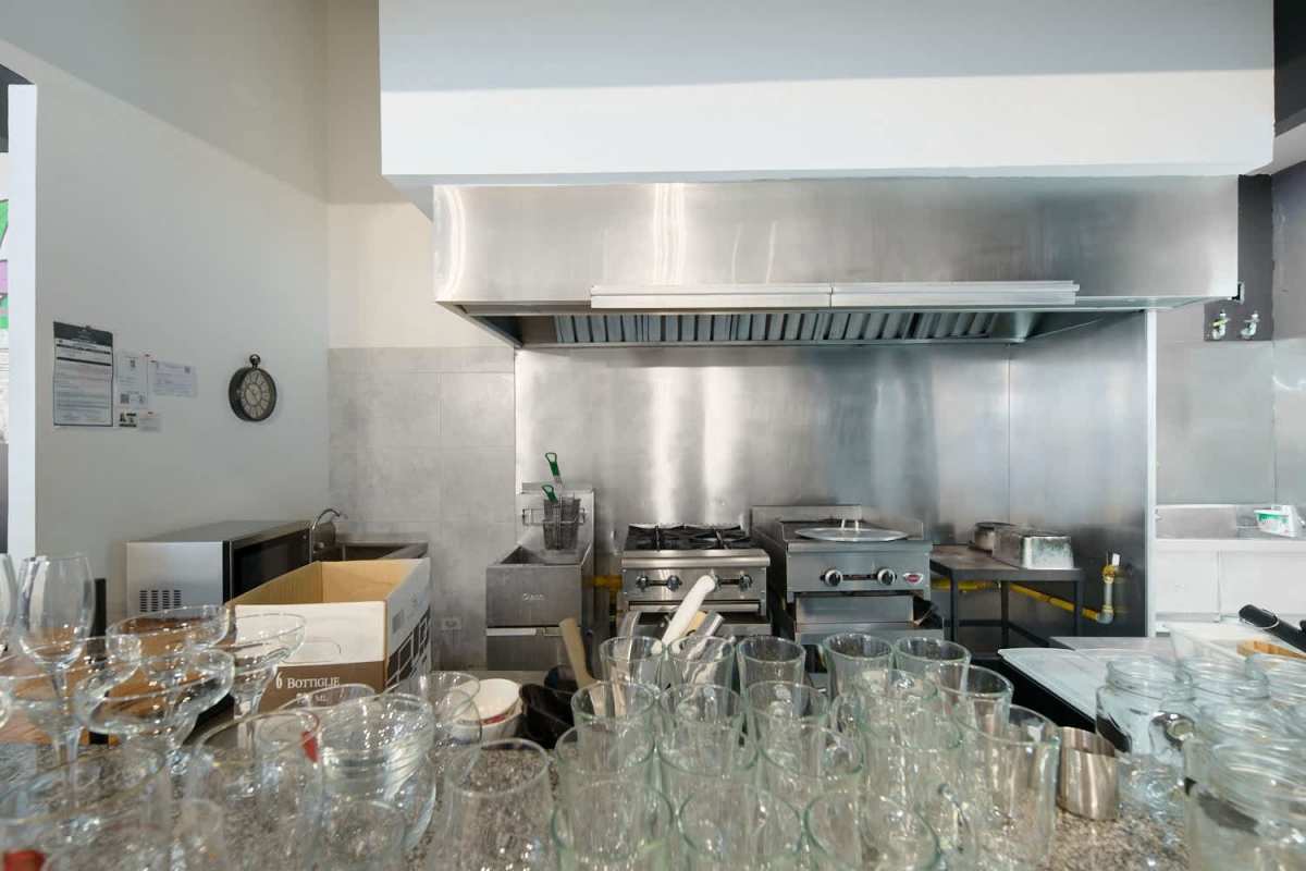 Dining area with multiple seating options, large ceiling fan, glass walls in PH BICSA Panama City