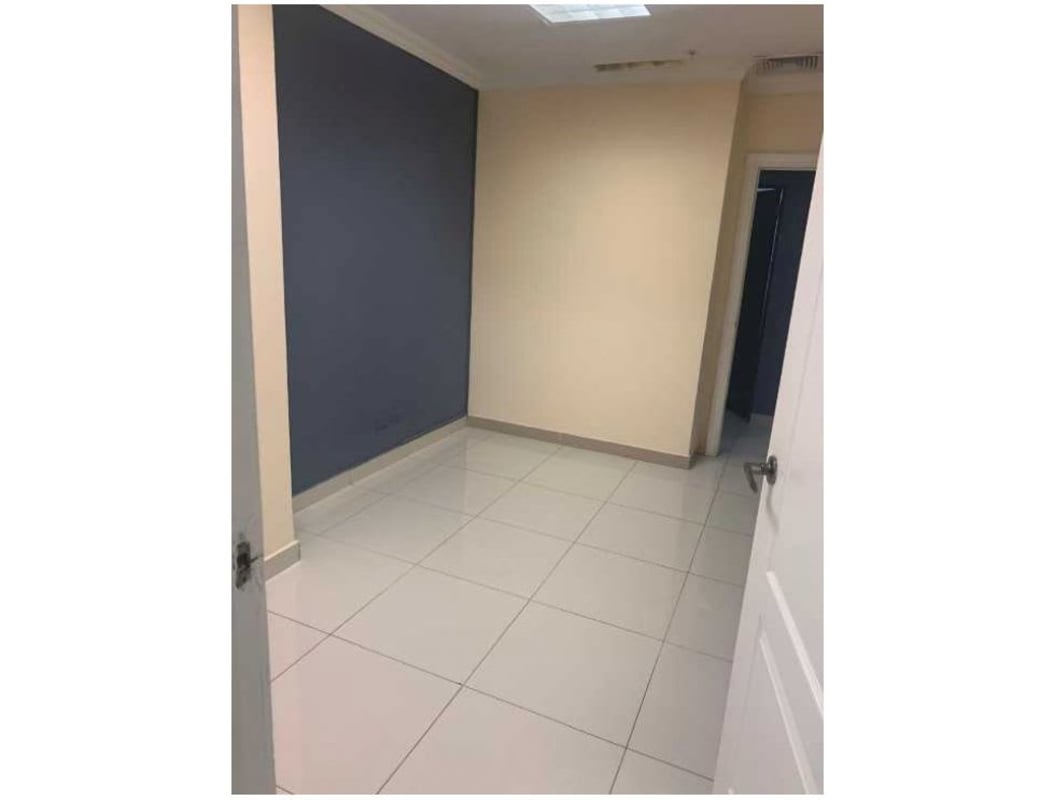 Urban environment in Costa del Este with palm trees, shops, parking near PH Top Tower Panama