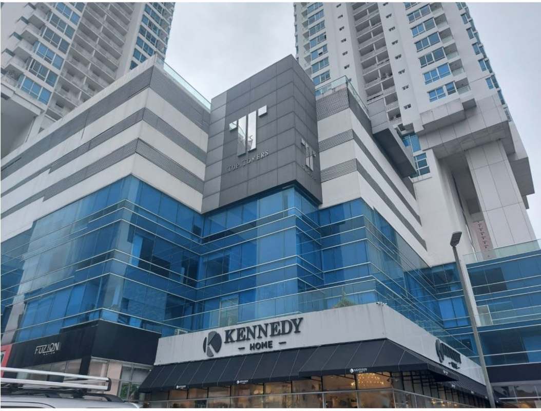 High-rise PH Top Tower with blue glass facade, retail spaces below in Costa del Este Panama